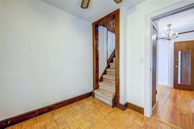 Staircase with baseboards and a chandelier | Image 33