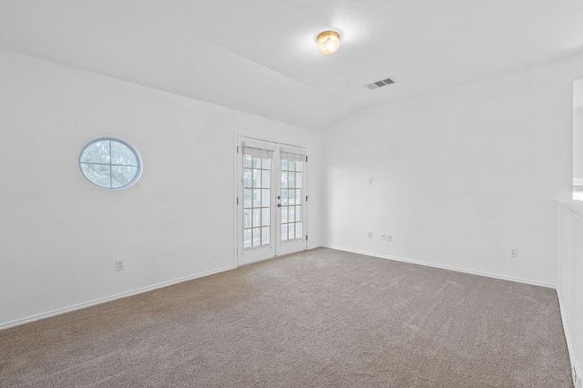 Carpeted spare room with lofted ceiling and baseboards | Image 14