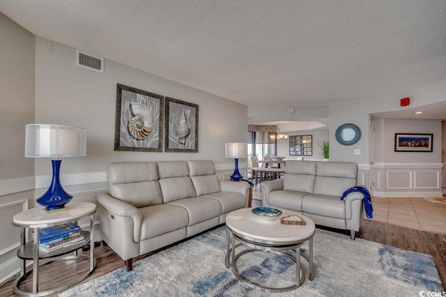 Living room featuring wood-type flooring, a chandelier, and a textured ceiling | Image 7