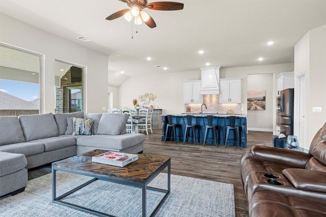 Living area with recessed lighting, a ceiling fan, and dark wood-type flooring | Image 7