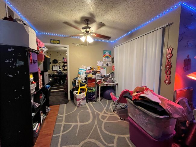Recreation room with a textured ceiling and ceiling fan | Image 7