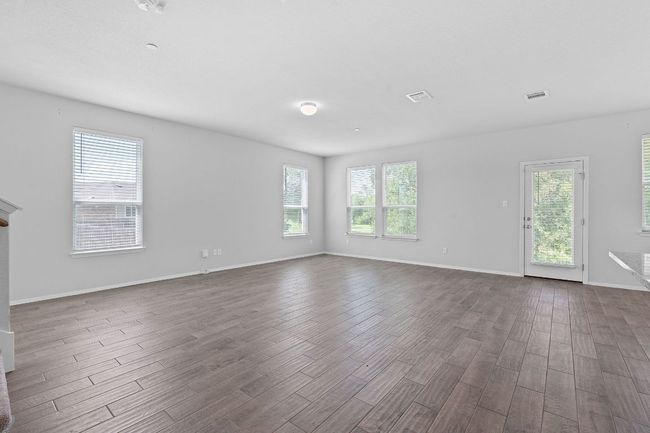 Spare room with dark wood finished floors and baseboards | Image 7