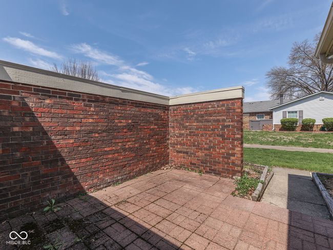Patio is surrounded by a brick wall for extra privacy | Image 5