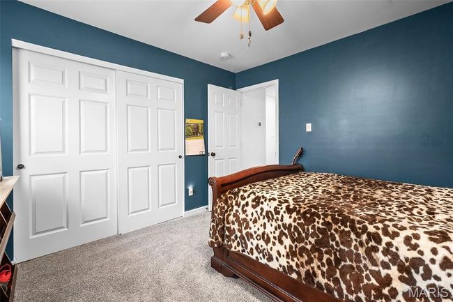 Carpeted bedroom with a closet and ceiling fan | Image 36