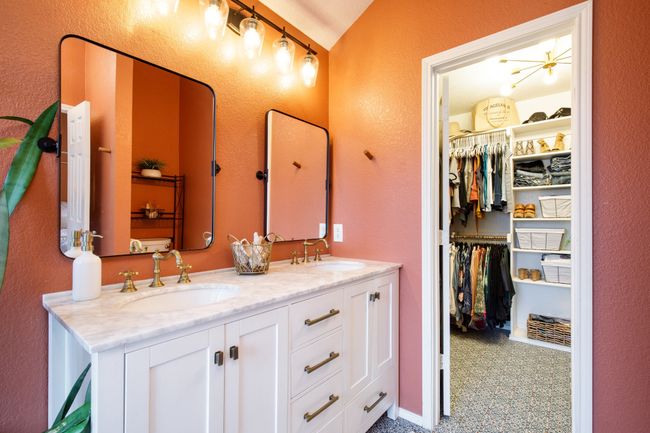 Full bathroom featuring double vanity, a spacious closet, tile patterned floors, and a textured wall | Image 18