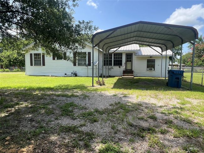 View of car parking with a carport, entry steps, and driveway | Image 25