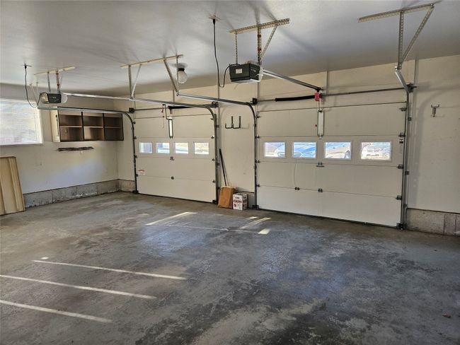 The oversized two car garage has automatic door openers. | Image 22