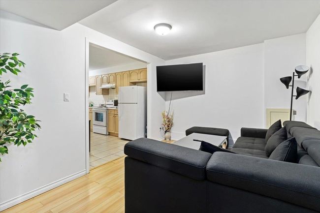 Living room featuring light wood-style flooring and baseboards | Image 22