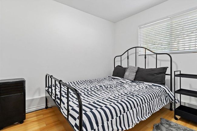 Bedroom with baseboards and wood finished floors | Image 29