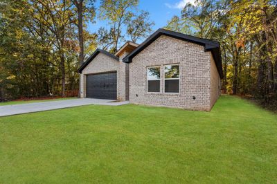 View of front of property with a front yard and a garage | Image 3