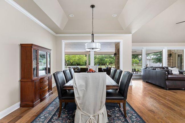 Large windows fill the space with natural light and offer views of the surrounding landscape. | Image 10