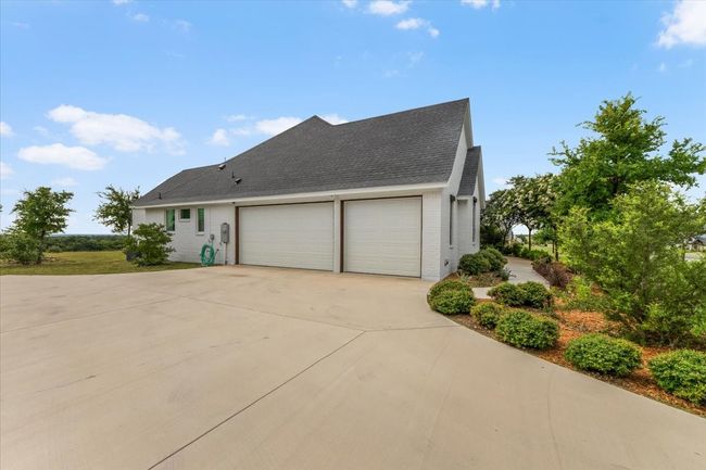 Side view of home with 3 car garage & landscaping | Image 35