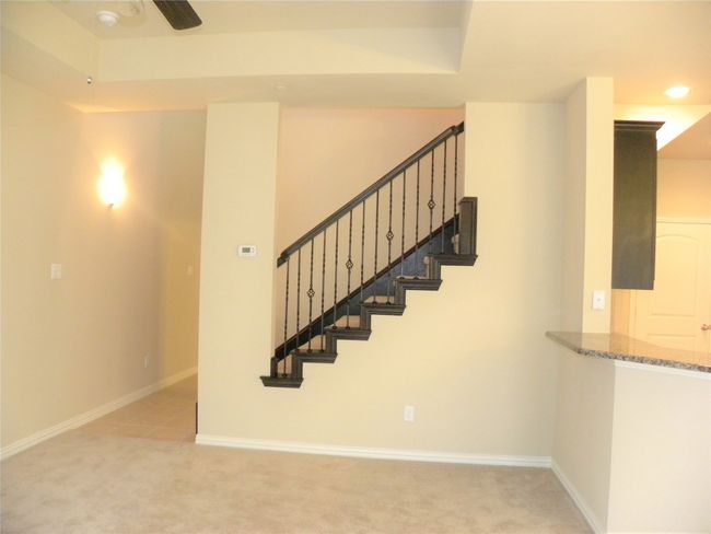 Staircase with carpet floors, a ceiling fan, and recessed lighting | Image 4