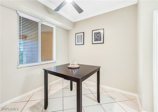 Home office with ornamental molding, light tile patterned floors, and ceiling fan | Image 10