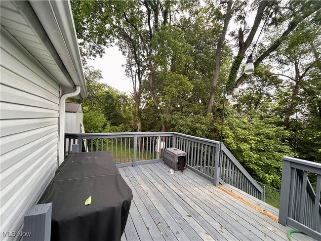 Wooden deck featuring view of scattered trees | Image 15