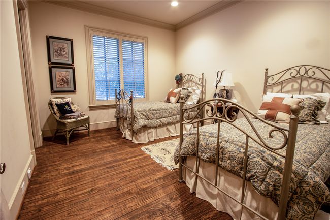 Bedroom with baseboards, ornamental molding, and wood finished floors | Image 17