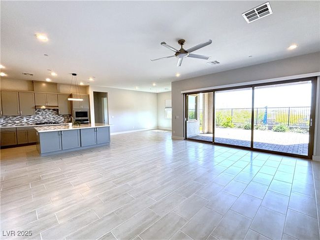 Unfurnished living room featuring baseboards, visible vents, a ceiling fan, and recessed lighting | Image 6
