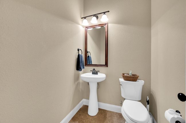 Half bath with toilet, tile patterned floors, and baseboards | Image 22