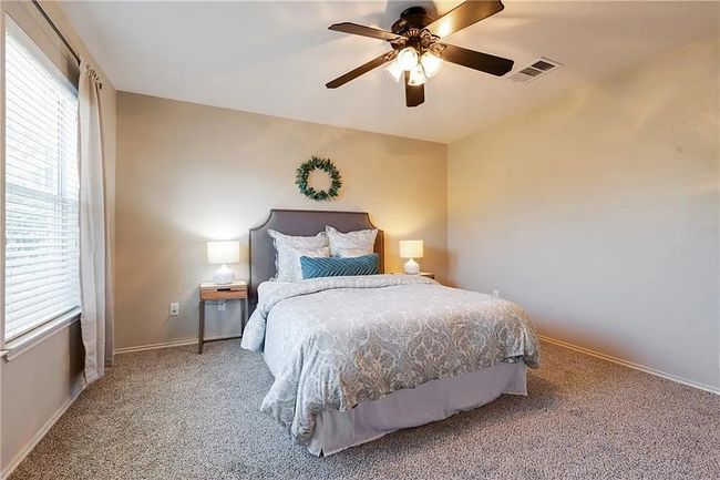 Bedroom featuring carpet floors, baseboards, and ceiling fan | Image 10