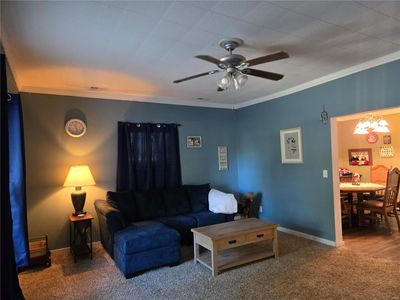 Living room featuring ornamental molding, carpet, and ceiling fan | Image 3