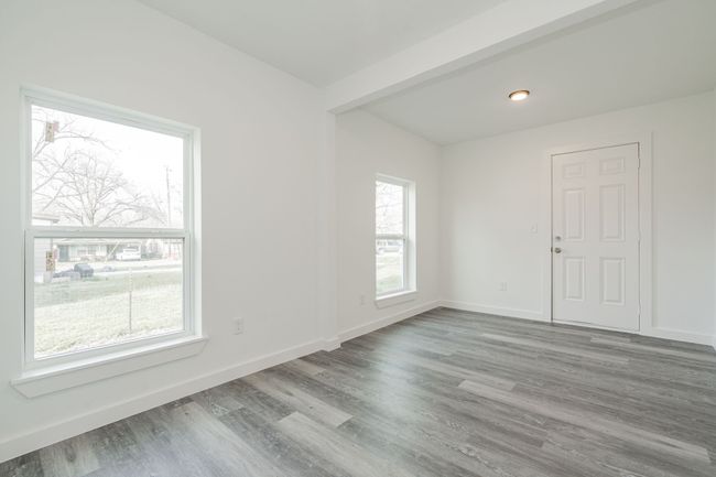 Empty room featuring baseboards and wood finished floors | Image 11