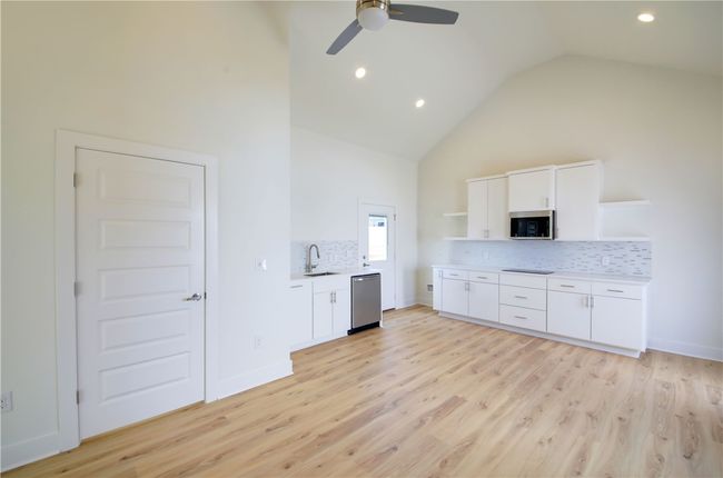 Stainless steel appliances with quartz countertops and backsplash. | Image 5