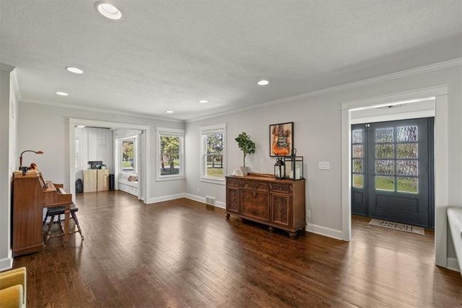 Foyer entrance featuring a textured ceiling, a wealth of natural light, recessed lighting, and ornamental molding | Image 13