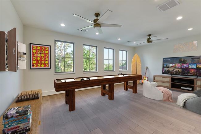 This game room area is perfect for family fun or as an ideal play area, offering plenty of space for entertainment and activities. Virtually staged. | Image 34
