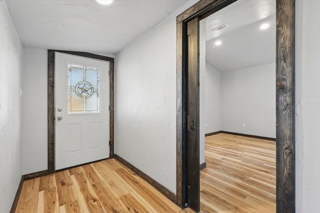Entryway featuring baseboards and light wood-style flooring | Image 13