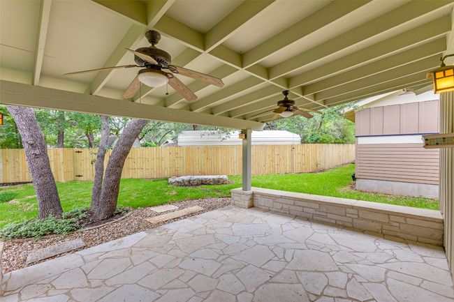 Fenced backyard featuring a ceiling fan and a patio area | Image 26