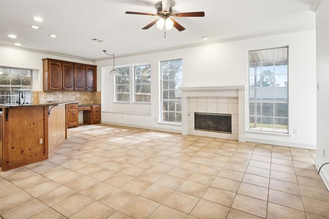 Family Room with view of breakfast room window seat, built in desk and island. Wonderful windows to let in lots of light | Image 12