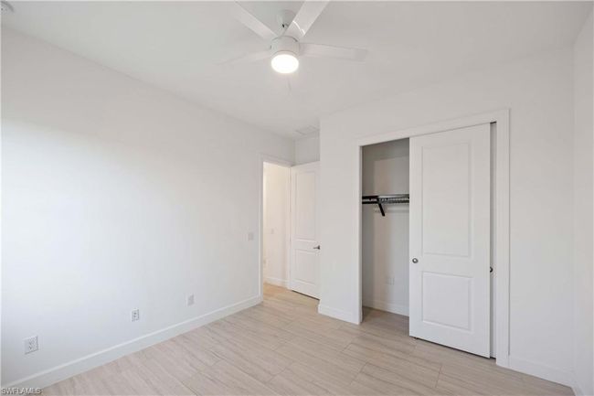 Unfurnished bedroom with a closet, baseboards, and ceiling fan | Image 20