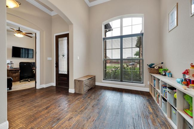 Foyer featuring ornamental molding, arched walkways, baseboards, ceiling fan, and dark wood-style floors | Image 5