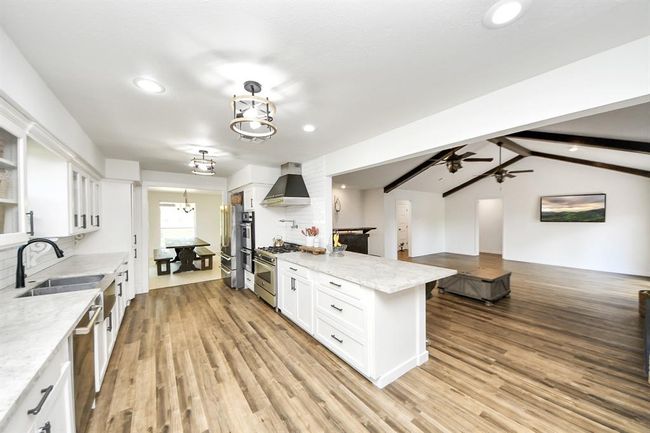 Enjoy effortless entertaining—prep meals while staying part of the conversation with views from the kitchen into the spacious living room. | Image 9