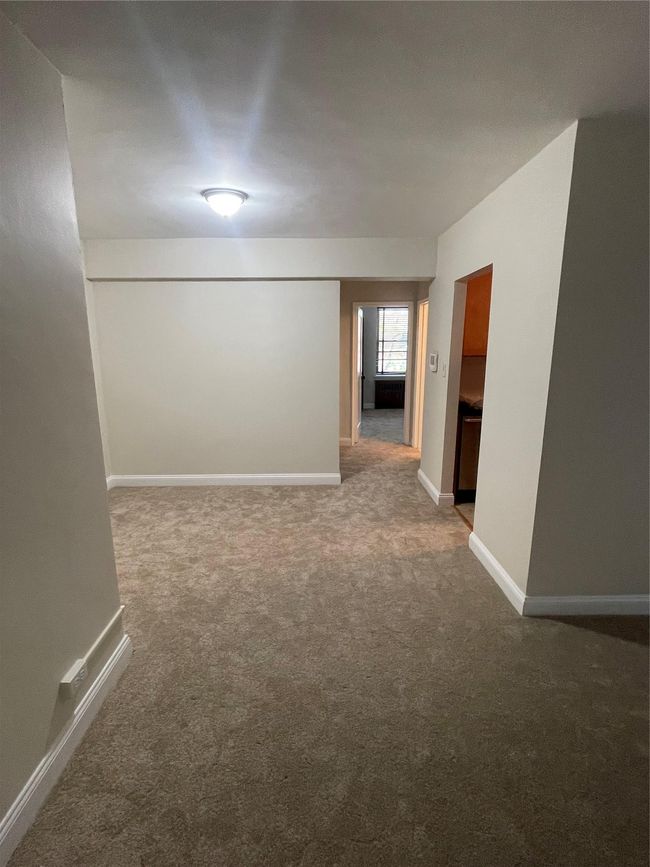 Carpeted empty room featuring baseboards | Image 8