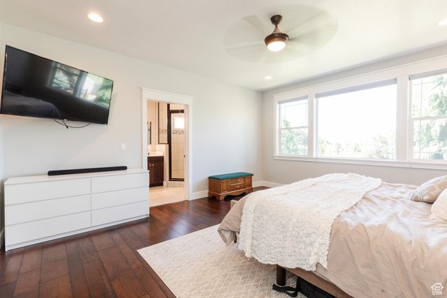 Bedroom featuring dark wood-style floors, recessed lighting, connected bathroom, and a ceiling fan | Image 22