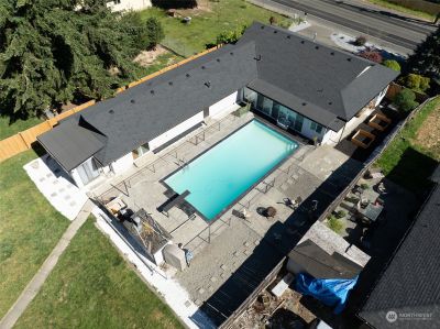 This 38 x 18 Pool is Ready for Summer Fun! Fully Fenced and gated for safety. There's a gravel party/BBQ area with concrete slabs in place to setup umbrellas and or awnings to one side, garden space, and then lawn between the house and shop. | Image 2