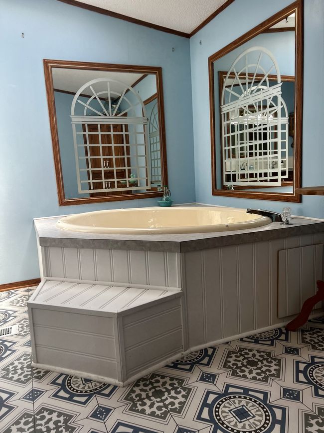This bathroom is built for relaxing with a garden tub. A skylight overhead completes the experience. Custom tile flooring sweetens the space. | Image 21