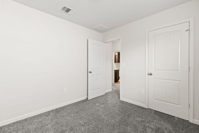 Unfurnished bedroom featuring carpet flooring and baseboards | Image 18
