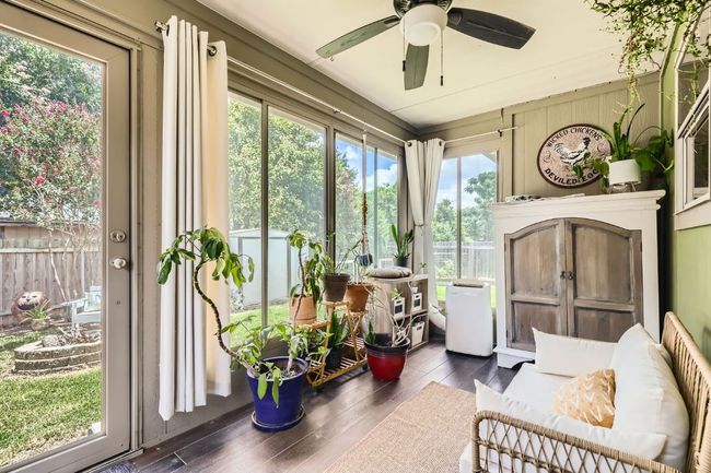 Sunroom with wood finished floors, and included portable air conditioner | Image 23