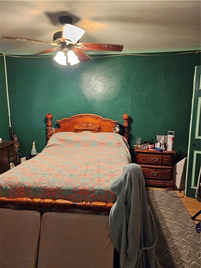 Bedroom featuring wood finished floors and a ceiling fan | Image 7