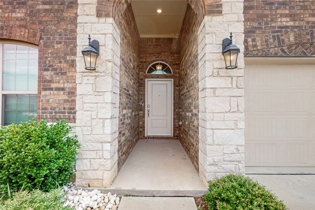 View of exterior entry with brick siding and stone siding | Image 5