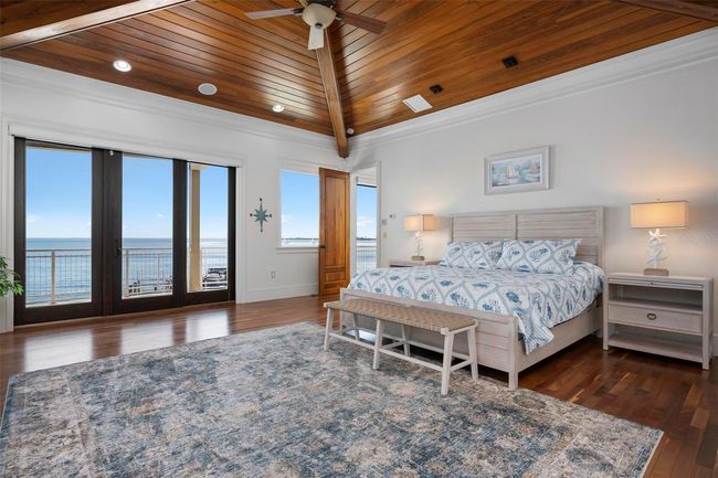 Primary bedroom with sliding doors to the balcony overlooking the intracoastal bay water views | Image 39