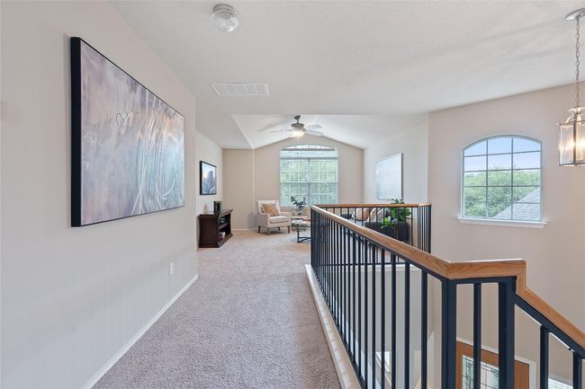 Hall featuring lofted ceiling, carpet floors, an upstairs landing, and a chandelier | Image 21