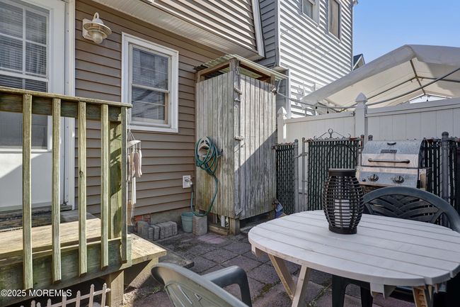 Fenced backyard with an outdoor shower and gas grill. Great yard to entertain. | Image 7