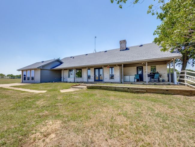 Driveway is on the far left of this photo just outside of the second living area. Double doors lead into the main family room. Single door on the right leads into the primary suite. | Image 35