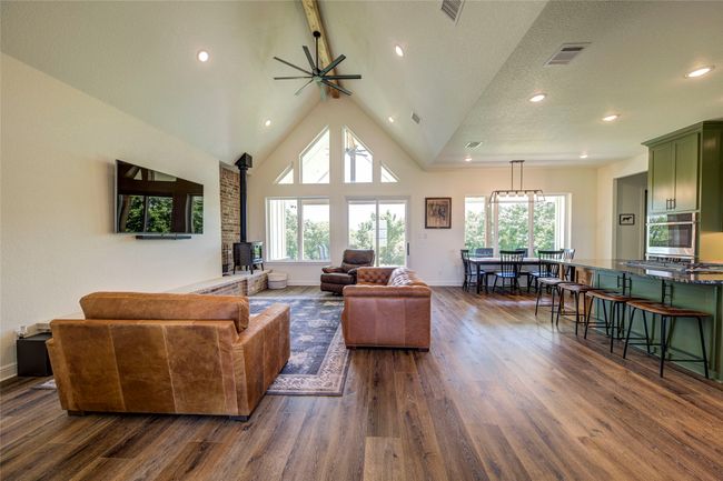 Living room with high vaulted ceiling, an inviting chandelier, and dark hardwood / wood-style flooring | Image 5
