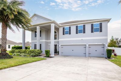 This amazing home with 6 bedrooms, 4 full Baths and a half 3912 sf ft of heated living space, sits on just over a quarter of an acre premium lot. It has a 3 car garage, and a covered front porch with towering columns that add to its charm and curb appeal. Will you join me on a tour? You won't be disappointed. | Image 2