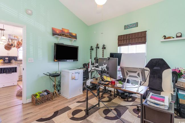 Office area with a ceiling fan, vaulted ceiling, and wood finished floors | Image 16