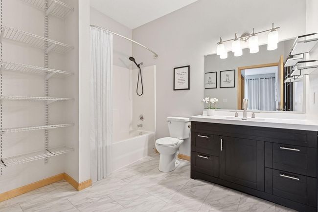 Both bathrooms completely remodeled with new vanities, toilets, sinks, light fixtures, luxury tile flooring and more | Image 14